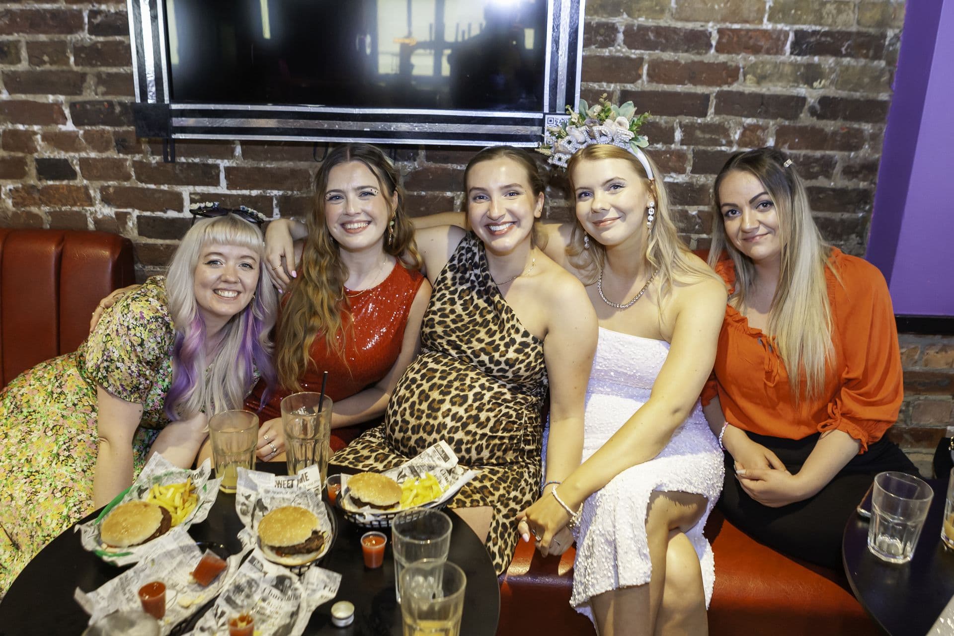 A work group raising glasses at a bottomless brunch